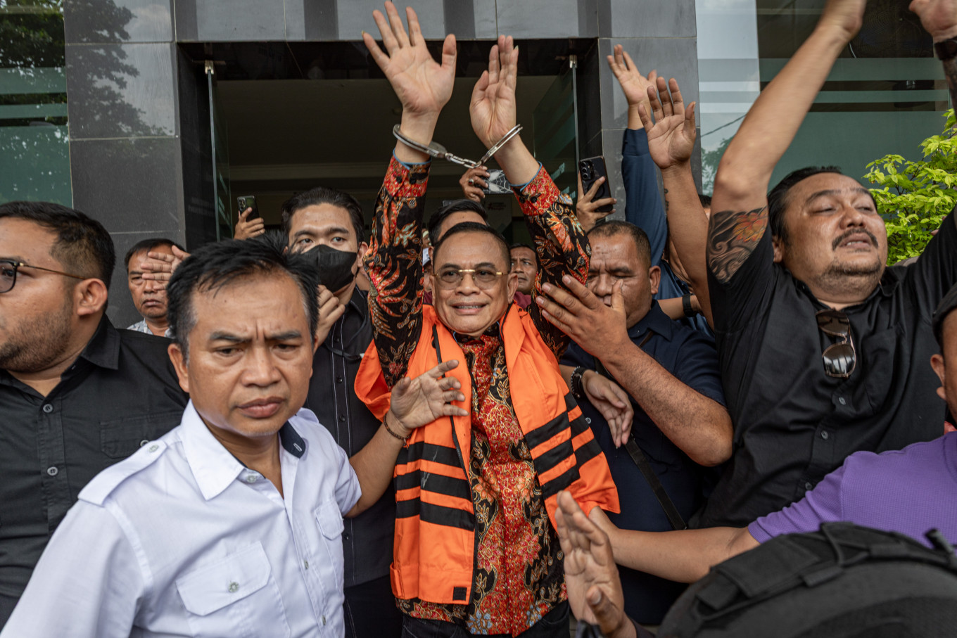 Suspended Pati Regent Sudewo greets supporters after attending the opening trial in his corruption case on June 15 at the Corruption Court in Semarang, Central Java. Prosecutors from the Corruption Eradication Commission accused Sudewo of accepting bribes and gratuities totaling 3.8 billion rupiah (about $233,000) related to railway projects at the Transportation Ministry while serving as a member of parliament from 2021 to 2023, and of allegedly extorting 2.6 billion rupiah (about $160,000) in the recruitment of village officials in Pati regency from 2025 to 2026 while serving as regent. 