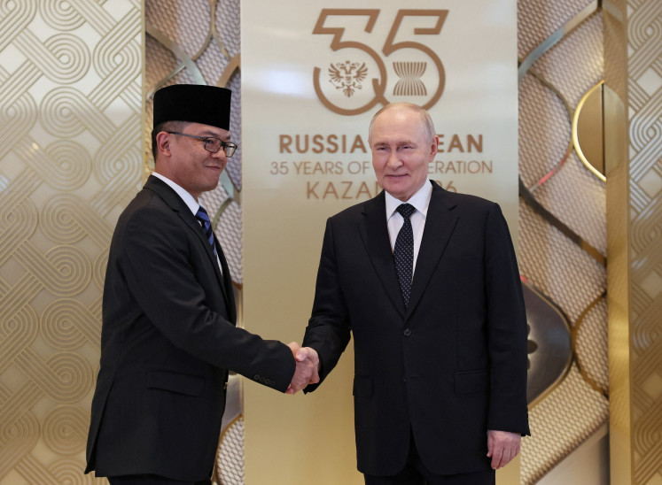 Russian President Vladimir Putin (right) shakes hands with Indonesian Foreign Minister Sugiono during an official welcoming ceremony for the heads of delegations participating in the Russia-ASEAN Summit in Kazan, Russia, on June 17, 2026. 