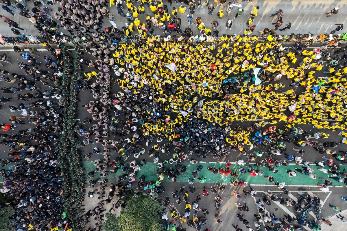This aerial picture shows students protesting to demand a reduction in fuel prices and the dissolution of the free nutritious meal program, which they consider to be a hotbed of corruption, in Jakarta on June 12, 2026. 