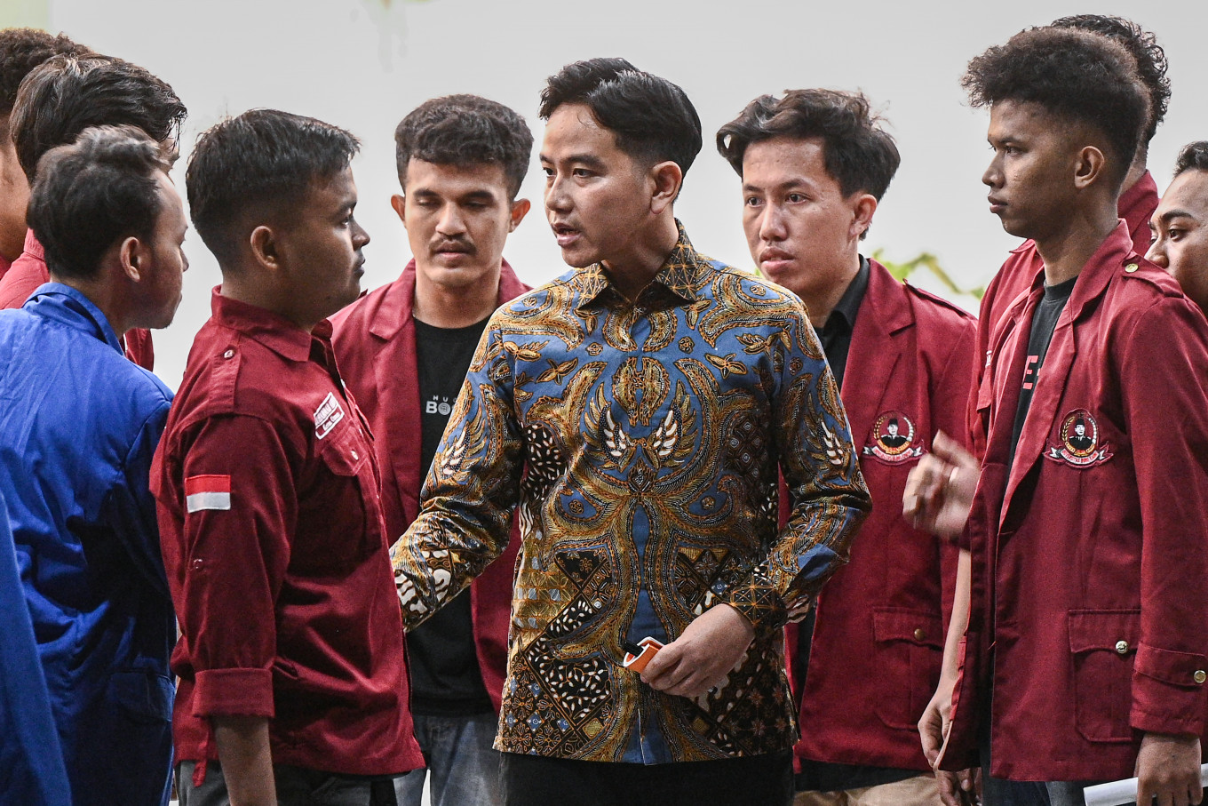 Vice President Gibran Rakabuming Raka (center) talks with student protesters after receiving them in a meeting at the Vice Presidential Palace in Central Jakarta on June 15, 2026. In the meeting, Gibran reportedly took notes of their concerns in a small notebook. 