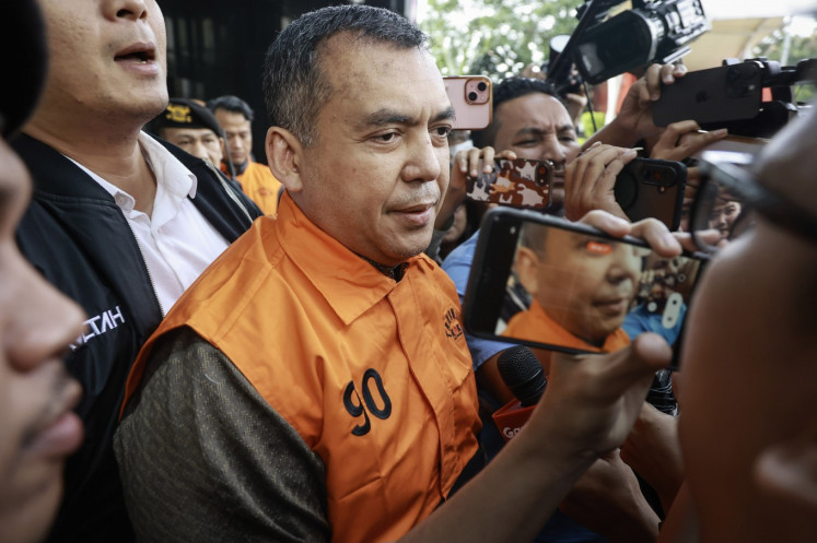 Deputy Immigration and Corrections Minister Silmy Karim (center) walks wearing a detainee vest after questioning at the Corruption Eradication Commission (KPK) headquarters in Jakarta on June 4, 2026. 