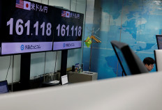 An employee of the foreign exchange trading company Gaitame.com works in front of monitors displaying the current Japanese Yen exchange rate against the US dollar, at their dealing room in Tokyo on June 19, 2026.
