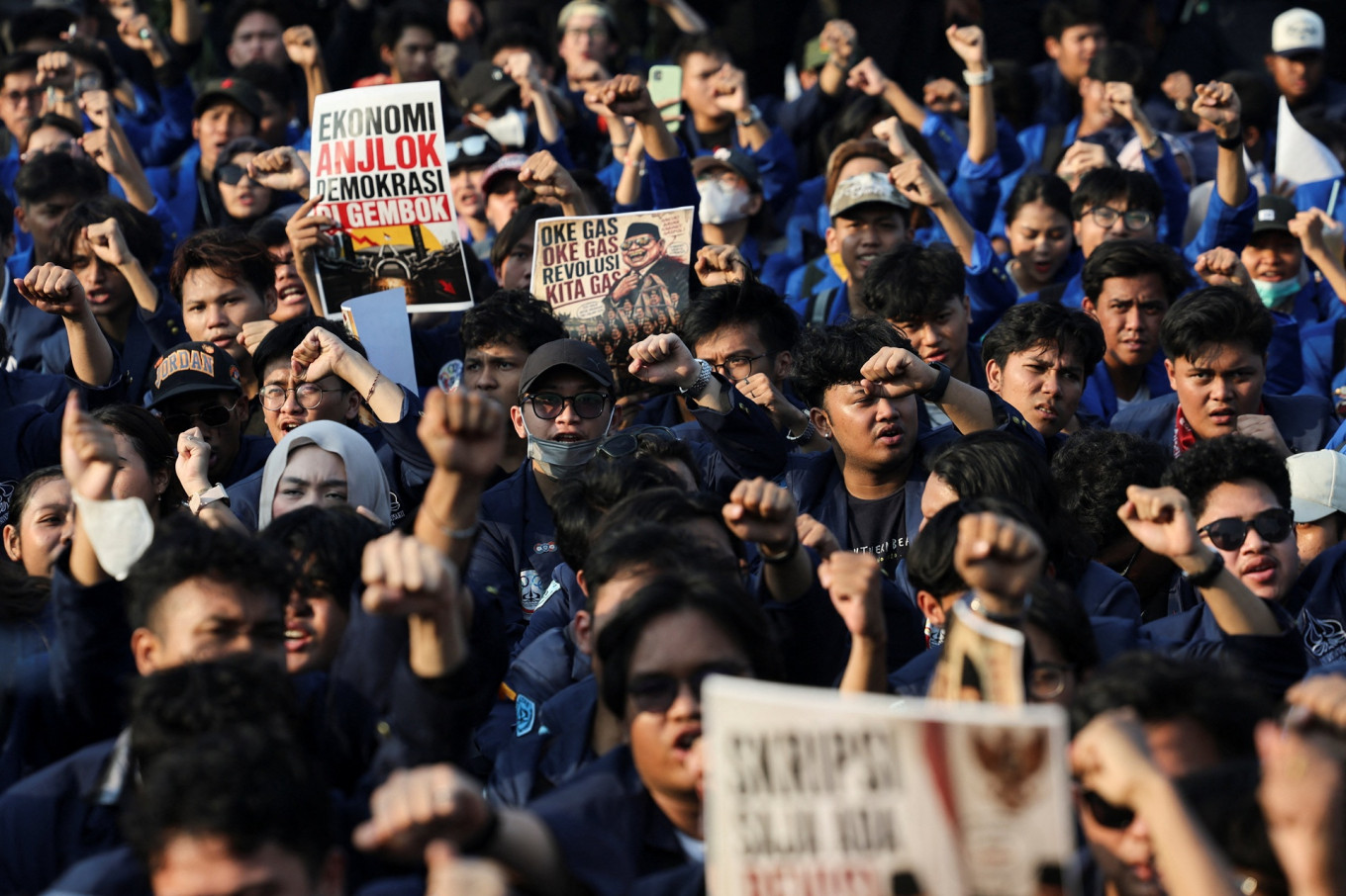 University students hold placards during a protest on June 19 outside the Senayan legislative complex in Central Jakarta against government policies, including state budget spending, fuel price hikes, the free nutritious meal program and expanded military roles in civilian affairs.