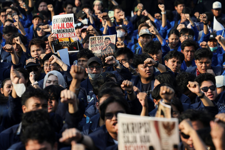 University students hold placards during a protest on June 19 outside the Senayan legislative complex in Central Jakarta against government policies, including state budget spending, fuel price hikes, the free nutritious meal program and expanded military roles in civilian affairs.