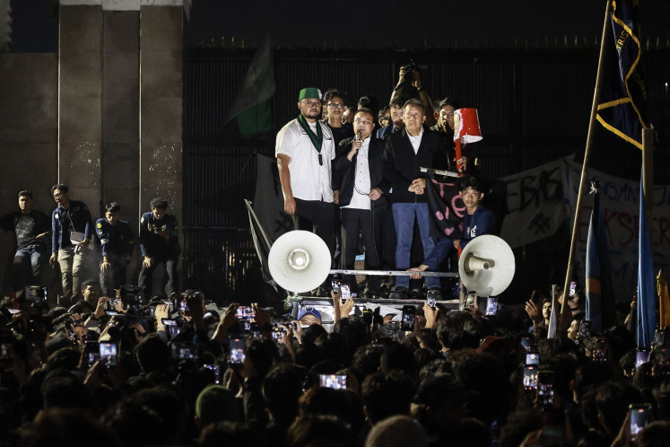 House of Representatives deputy speakers Sufmi Dasco Ahmad (center) of the Gerindra Party and Saan Mustopa (right) of the NasDem Party address studnt protesters in front of the Senayan legislative complex in Jakarta during a protest on June 19, 2026 against government policies, including state budget spending, fuel price hike, the free nutritious meal program and expanded military roles in civilian affairs.