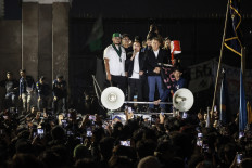 House of Representatives deputy speakers Sufmi Dasco Ahmad (center) of the Gerindra Party and Saan Mustopa (right) of the NasDem Party address studnt protesters in front of the Senayan legislative complex in Jakarta during a protest on June 19, 2026 against government policies, including state budget spending, fuel price hike, the free nutritious meal program and expanded military roles in civilian affairs.
