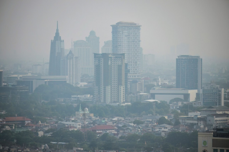 The city skyline is enveloped in pollution haze in Jakarta on May 7, 2026.
