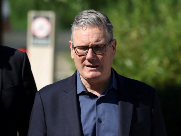 Britain's Prime Minister Keir Starmer walks as he visits a housing development in north London, Britain, June 19, 2026.