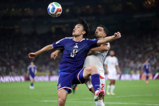 Japan's forward #18 Ayase Ueda and Tunisia's defender #21 Mohamed Ben Hamida fight for the ball during the 2026 World Cup Group F football match between Tunisia and Japan at the Monterrey Stadium in Guadalupe, Mexico, on June 20, 2026.  
