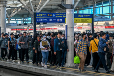 Commuter train passengers from satellite cities leave the station on Nov. 8, 2024, upon arriving in Jakarta during the morning rush hour.