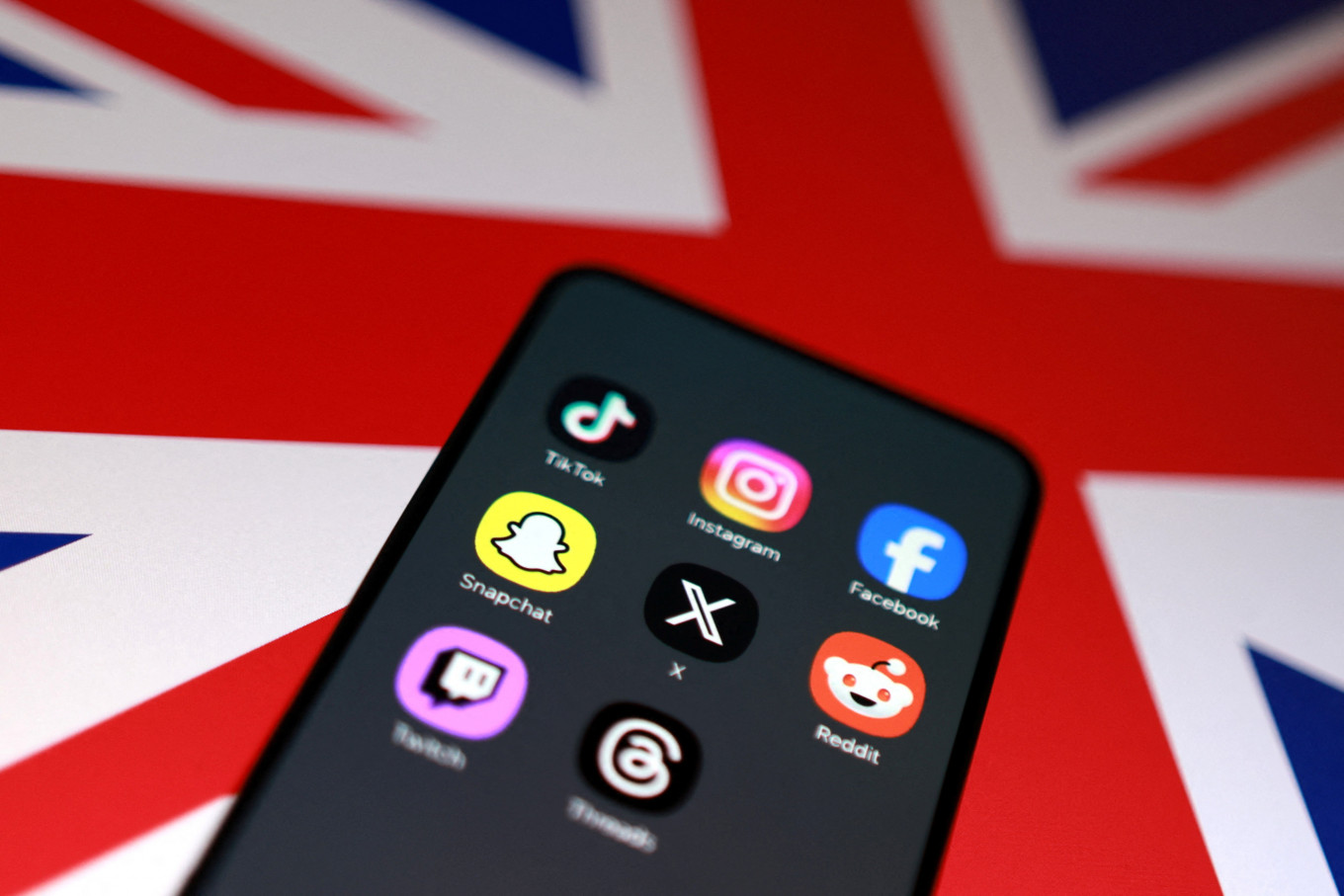 A Union Jack flag and social media app icons are seen in this illustration taken June 15, 2026.
