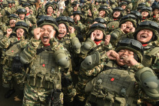 Civil servant participants in the first wave of the 2026 Reserve Component (Komcad) basic military training program chant slogans on June 5, 2026, after a graduation ceremony at Halim Perdanakusuma Air Force Base in East Jakarta. A total of 1,758 participants completed the training and were inducted into the national reserve force.