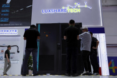 People check a display of a solid-state transformer at the Luxshare Tech booth during the China International Supply Chain Expo (CISCE) in Beijing on June 22, 2026.