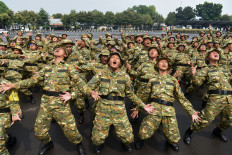 Participants in Indonesia's Bachelor of Development Mobilizer Program (SPPI) chant slogans on Thursday during basic military training for prospective managers of the Red and White Rural Cooperatives (KDMP) at the 1st Marine Infantry Brigade in Cilandak, Jakarta. A total of 674 participants are undergoing the training, which is designed to build the integrity, loyalty, discipline, teamwork and empathy required to serve as managers of the rural cooperatives. 