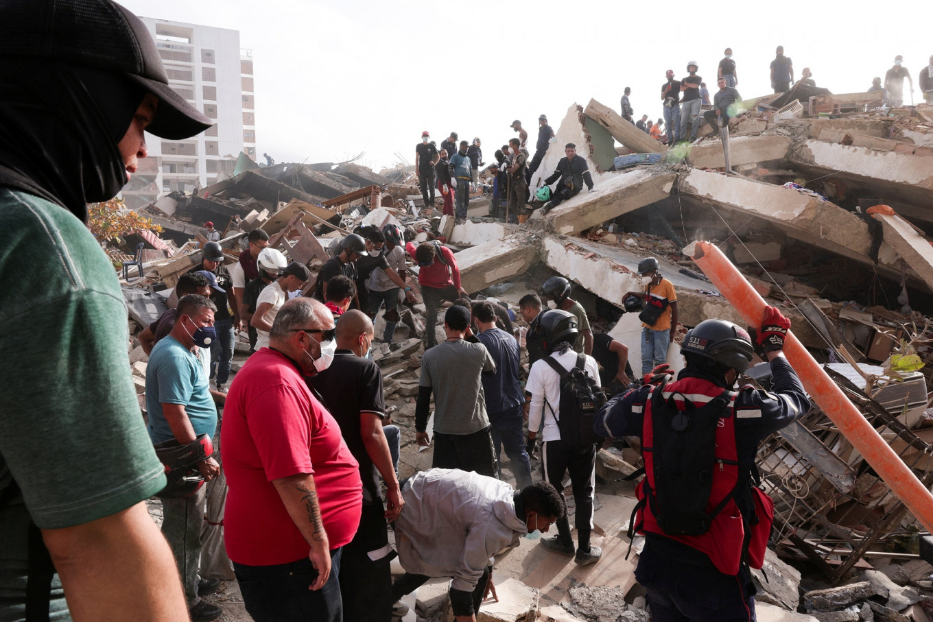 Firefighters and volunteers work amidst the rubble of a collapsed building in La Guaira, Venezuela on June 26, 2026 after earthquakes hit the country.