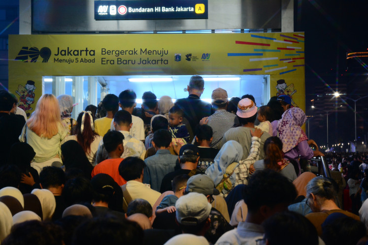 People wait in line to enter an MRT station after attending the peak celebration of Jakarta's 499th anniversary near the Hotel Indonesia traffic circle on June 27, 2026. The Jakarta administration marked the city's 499th anniversary under the theme &ldquo;Toward Five Centuries of Jakarta,&ldquo; featuring a variety of entertainment and cultural performances.
