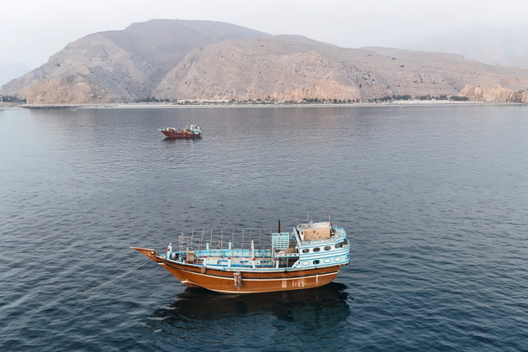 This aerial photograph shows boats anchored off Oman&rsquo;s northern Musandam Peninsula near the Strait of Hormuz on June 27, 2026. Iran launched attacks on US sites in the Gulf in response to American strikes on the country, state media said on June 27, after Washington accused Tehran of attacking one of its cargo ships in the Strait of Hormuz. 