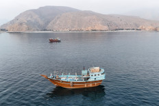This aerial photograph shows boats anchored off Oman&rsquo;s northern Musandam Peninsula near the Strait of Hormuz on June 27, 2026. Iran launched attacks on US sites in the Gulf in response to American strikes on the country, state media said on June 27, after Washington accused Tehran of attacking one of its cargo ships in the Strait of Hormuz. 