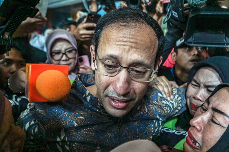 Nadiem Anwar Makarim (center), accused of corruption in the procurement of Chromebook laptops when he was education minister, arrives with supporters at the Corruption Court in Central Jakarta, on June 30, 2026. The court was scheduled to deliver its verdict in the case. 