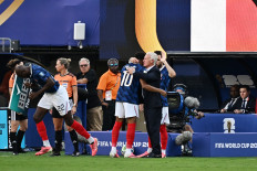 France's forward #10 Kylian Mbappe hugs head coach Didier Deschamps as he leaves the pitch after being substituted during the 2026 World Cup round of 32 football match between France and Sweden at the New York/New Jersey Stadium in East Rutherford on June 30, 2026.  
