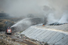 Firefighters work to extinguish a blaze at the Jatiwaringin landfill in Tangerang regency, Banten, on June 30, 2026.