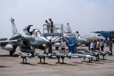 President Prabowo Subianto (left) looks inside the cockpit of a Rafale jet fighter during a ceremony to hand over six new Rafale jet fighters, four Dassault Falcon 8X aircrafts and one Airbus A400M Atlas aircraft to the Air Force at Halim Perdanakusuma Air Force Base in Jakarta on May 18, 2026.