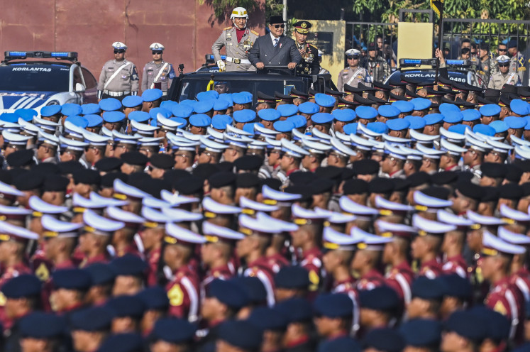 President Prabowo Subianto (center), accompanied by National Police chief Gen. Listyo Sigit Prabowo (right), conducts an inspection during a ceremony commemorating the 80th National Police Day on July 1 at a police training facility in Cikeas, Bogor, West Java.
