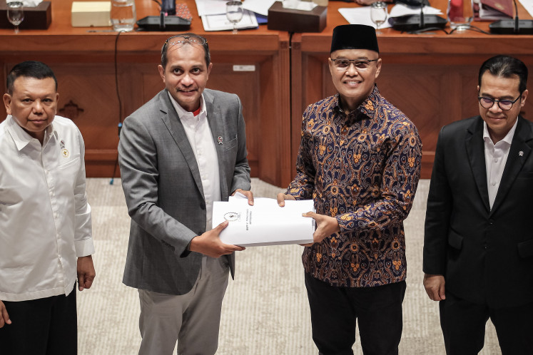 House of Representatives Commission I deputy chair Sukamta (second right) hands the list of issues for deliberation of the Cybersecurity and Resilience Bill to Deputy Law Minister Edward &ldquo;Eddy&ldquo; O.S. Hiariej (second left) during a working meeting on June 29 at the House complex in Senayan, Jakarta.