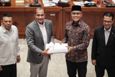 House of Representatives Commission I deputy chair Sukamta (second right) hands the list of issues for deliberation of the Cybersecurity and Resilience Bill to Deputy Law Minister Edward &ldquo;Eddy&ldquo; O.S. Hiariej (second left) during a working meeting on June 29 at the House complex in Senayan, Jakarta.