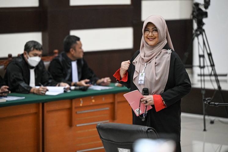 Health practitioner Tifauzia &ldquo;Tifa&rdquo; Tyassuma (right) arrives for the opening hearing of her defamation trial at the East Jakarta District Court on July 2, 2026. Prosecutors read the indictment accusing her of defaming former president Joko &ldquo;Jokowi&rdquo; Widodo by alleging that his university diploma was not authentic.