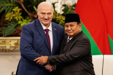 President Prabowo Subianto (right) and Belarusian President Alexander Lukashenko shake hands after attending a joint press conference on July 2 at the Merdeka Palace in Jakarta.