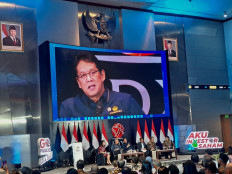 Finance Minister Purbaya Yudhi Sadewa's face is displayed on screen during his speech on Dec. 3, 2025, in the main hall of the Indonesia Stock Exchange (IDX) building in South Jakarta. 