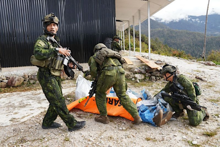 Personnel from the Indonesian National Armed Forces (TNI) Habema Joint Operations Command evacuate the body of PT AMA pilot Nicholas F. Goselin, 29, in Balinggama, Sobaham district, Yahukimo regency, Highland Papua, Indonesia, Thursday, July 2, 2026. Indonesian authorities said Goselin was allegedly shot by members of an armed criminal group. 