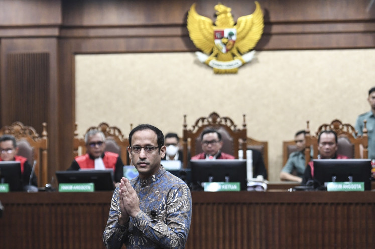Former education minister and cofounder of tech firm Gojek, Nadiem Makarim, poses on Tuesday ahead of his sentencing at the Jakarta Corruption Court in Central Jakarta. The judges sentenced him to 10 years in prison after finding him guilty of abusing his authority in the procurement of Chromebook laptops for schools nationwide between 2020 and 2022.