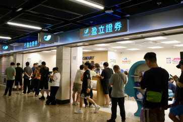 Individual investors visit a securities firm in the complex of the West Kowloon rail station in Hong Kong, China, on June 6, 2026. Beijing introduced new rules on July 1, 2026 to limit overseas investments, prompting some investors to open trading accounts in Hong Kong, where regulations differ to those on the mainland.