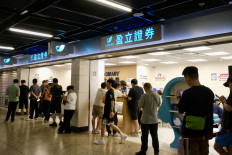 Individual investors visit a securities firm in the complex of the West Kowloon rail station in Hong Kong, China, on June 6, 2026. Beijing introduced new rules on July 1, 2026 to limit overseas investments, prompting some investors to open trading accounts in Hong Kong, where regulations differ to those on the mainland.