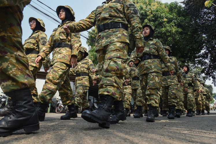 Participants of the Bachelor of Development Mobilizer Program (SPPI) march during a session of the nationalism and managerial training program for Red and White Cooperative manager candidates on June 30 at the Indonesian Army's Health Center in Kramat Jati, East Jakarta.
