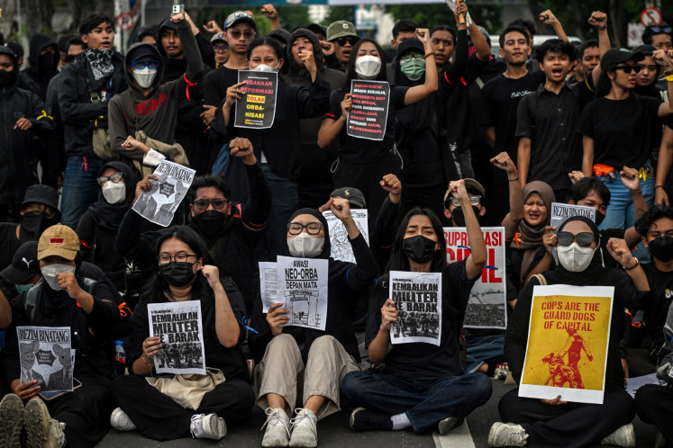 Students display placards reading &ldquo;Return the soldiers to the barracks&ldquo; during a protest against a revision to the Indonesian Military (TNI) Law in Surabaya, East Java on March 24, 2025.