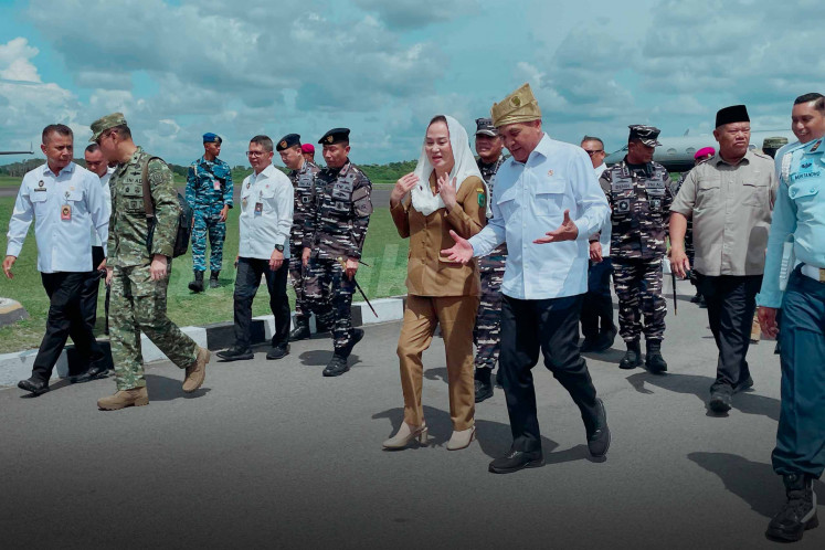 Coordinating Politics and Security Minister Gen. (hon) Djamari Chaniago (center left) talks with Natuna Regent Cen Sui Lan on July 2 upon arrival at Raden Sadjad Air Force Base in Ranai, Natuna, Riau Islands. Djamari was on a two-day trip visiting Natuna regency and Batam city. 