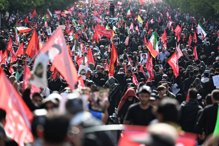 People gather at Ferdowsi Square for the funeral procession of Iran's slain Supreme Leader Ali Khamenei in Tehran July 6, 2026. 