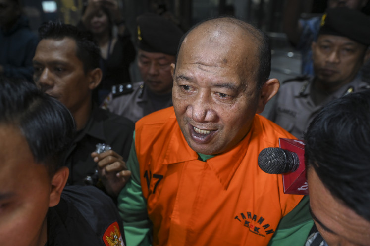 Langkat Regent Syah Afandin is escorted to a detention vehicle after questioning at the Corruption Eradication Commission (KPK) headquarters in Jakarta, on July 4, 2026. The KPK detained Afandin after naming him as a suspect in a bribery case related to public works projects in Langkat regency from 2025- 2026.