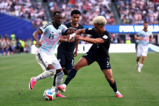 Dodi Lukebakio #14 of Belgium competes for the ball against Antonee Robinson #5 of the United States during the FIFA World Cup 2026 Round of 16 match between USA and Belgium at Seattle Stadium on July 06, 2026 in Seattle, Washington, US. 