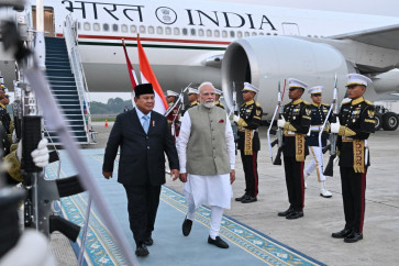 This handout photo taken and released on July 6, 2026 by the Presidential Palace shows President Prabowo Subianto (left) welcoming India's Prime Minister Narendra Modi upon his arrival at Halim Perdanakusuma Air Force Base in Jakarta. 