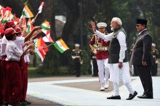 Indian Prime Minister Narendra Modi (second right), accompanied by President Prabowo Subianto, waves to students during a welcoming ceremony before their bilateral meeting at the Presidential Palace complex in Central Jakarta, on July 7, 2026.