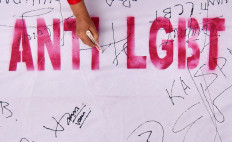 Residents sign a white banner during an anti-LGBT rally on June 21 in Padang, West Sumatra. The event, organized by the West Sumatra administration, the West Sumatra Police and the Minangkabau Traditional Council (LKAAM), invited participants to sign a one-kilometer-long white banner as part of a declaration opposing the LGBT community. Organizers also pledged to take action against LGBT individuals through customary law and called for them to be &ldquo;eradicated&ldquo; or expelled from the Minangkabau land. 