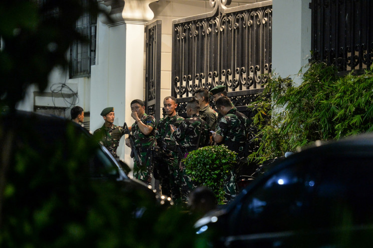 External reinforcements: A group of soldiers stands guard on Wednesday at the front gates of a luxury house in South Jakarta&rsquo;s upscale Kebayoran Baru neighborhood identified as the private residence of Febrie Ardiansyah, who resigned as assistant attorney general for special crimes on Friday amid an ongoing corruption investigation by the National Police.