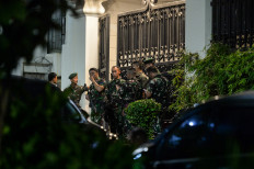 External reinforcements: A group of soldiers stands guard on Wednesday at the front gates of a luxury house in South Jakarta&rsquo;s upscale Kebayoran Baru neighborhood identified as the private residence of Febrie Ardiansyah, who resigned as assistant attorney general for special crimes on Friday amid an ongoing corruption investigation by the National Police.