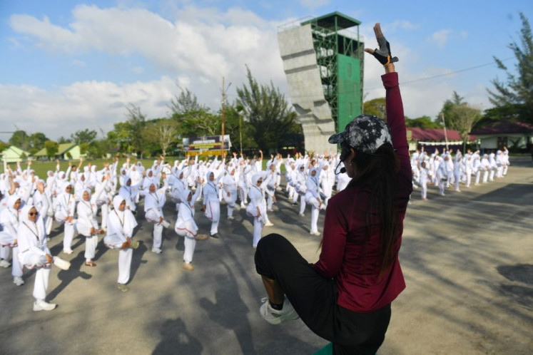Essential fitness: An instructor leads manager candidates of the Red and White Cooperatives program in morning calisthenics on July 5, 2026 as part of their obligatory defense training program at the compound of the Mulawarman Military Command in Balikpapan, East Kalimantan.