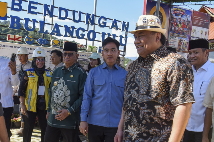 House of Representatives lawmaker Rachmat Gobel (second right) of the NasDem Party walks with Vice President Gibran Rakabuming Raka (third right) and Bone Bolango regent Ismet Mila on June 19 during an inspection of the construction site of the Bulango Ulu Dam in Bone Bolango regency, Gorontalo.