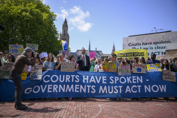 Vanuatu's Climate Change Minister Ralph Regenvanu (center) delivers a speech as he attends a demonstration ahead of the International Court of Justice (ICJ) session tasked with issuing the first Advisory Opinion (AO) on States' legal obligations to address climate change in The Hague, the Netherlands, on July 23, 2025.